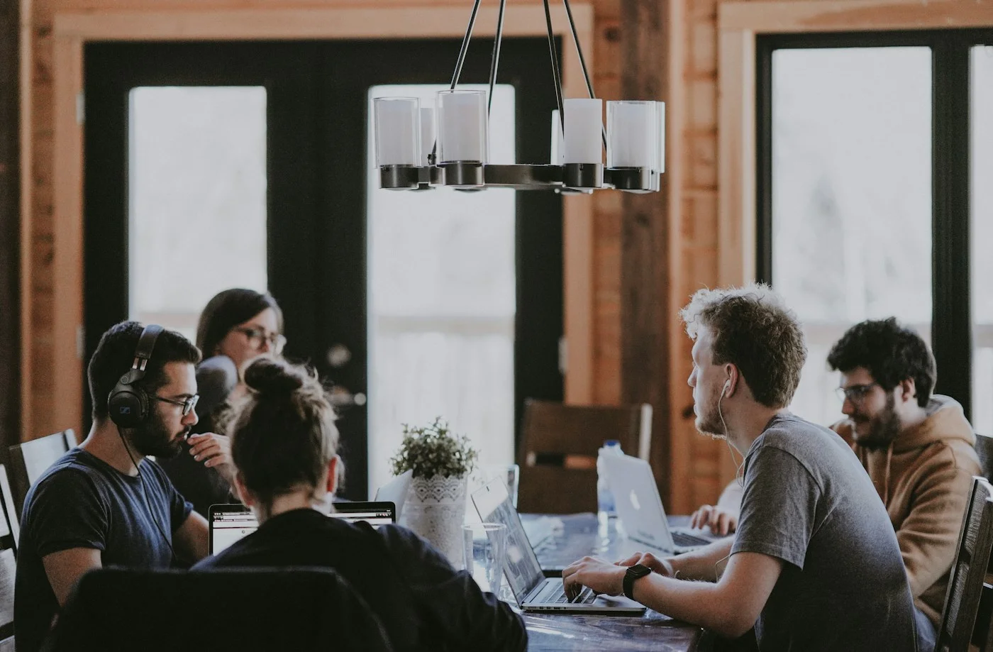 Engineers collaborating around a shared workspace.